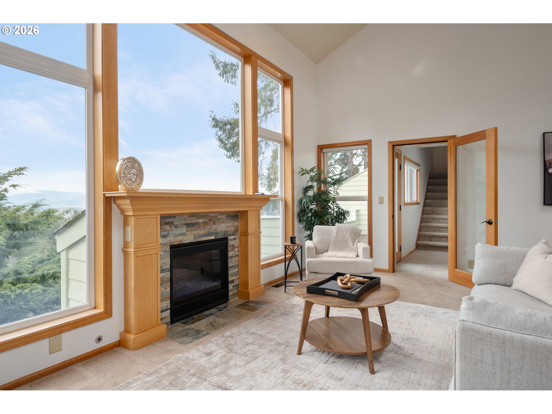 653 Brookside Drive Eugene, OR 97405 - Photo 9 of 48 a living room with furniture a window and a fireplace