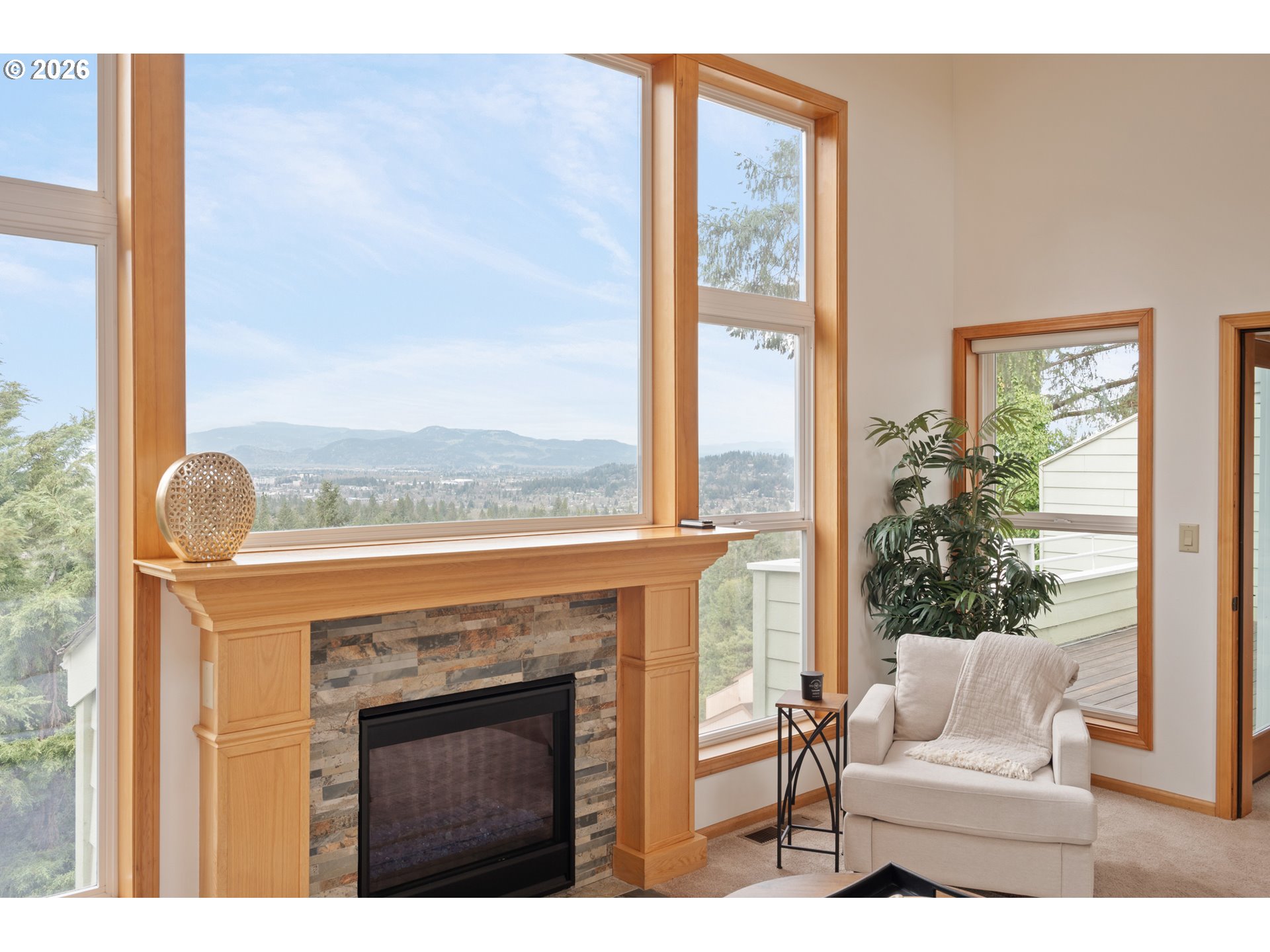 653 Brookside Drive Eugene, OR 97405 - Photo 10 of 48 a living room with a fireplace and a floor to ceiling window
