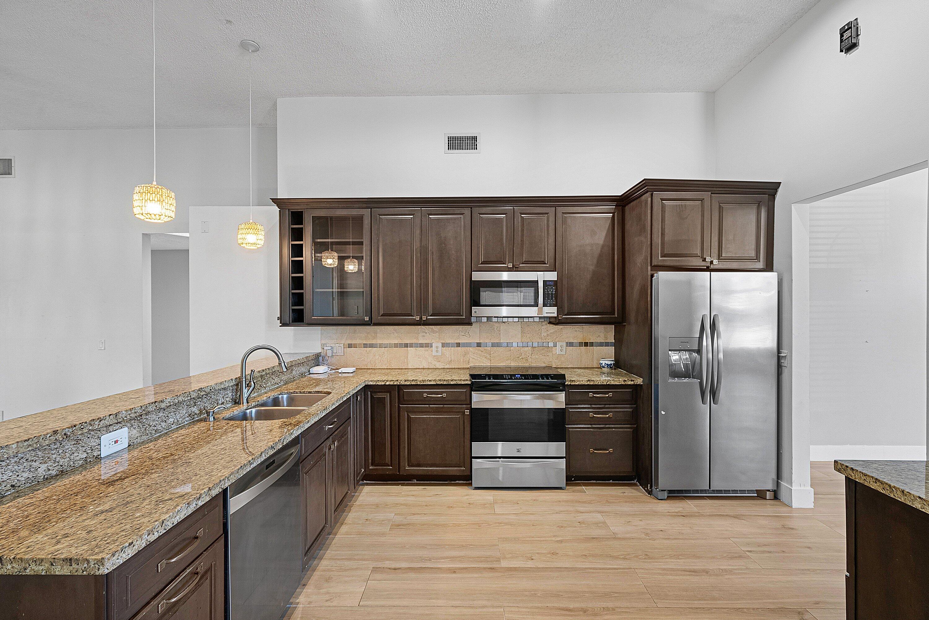 19712 Dinner Key Drive Boca Raton, FL 33498 - Photo 14 of 28 a large kitchen with cabinets stainless steel appliances and a counter space