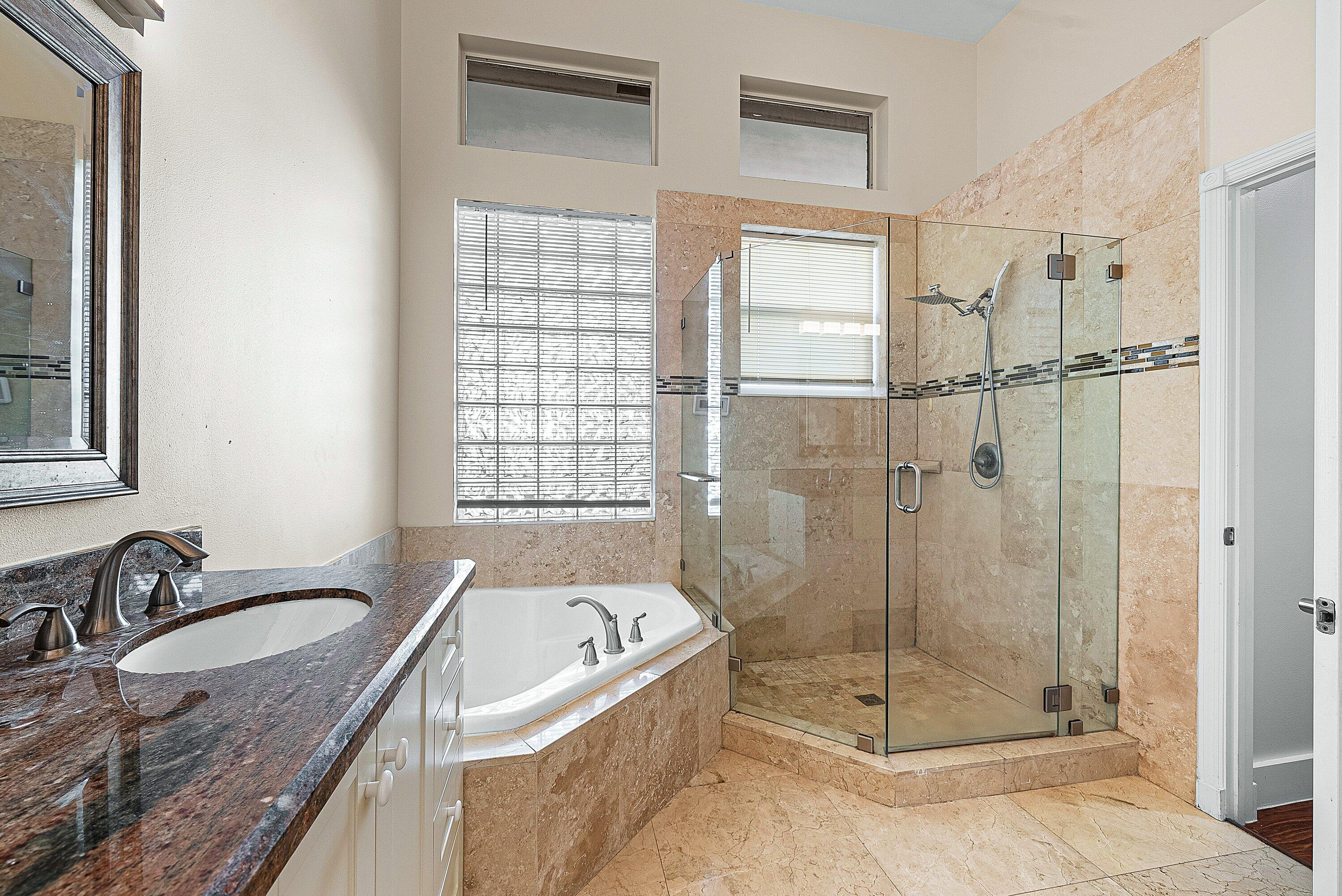 19712 Dinner Key Drive Boca Raton, FL 33498 - Photo 21 of 28 a bathroom with a granite countertop sink a mirror and a shower
