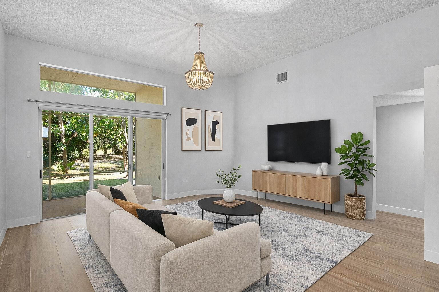 19712 Dinner Key Drive Boca Raton, FL 33498 - Photo 8 of 28 a living room with furniture and a flat screen tv
