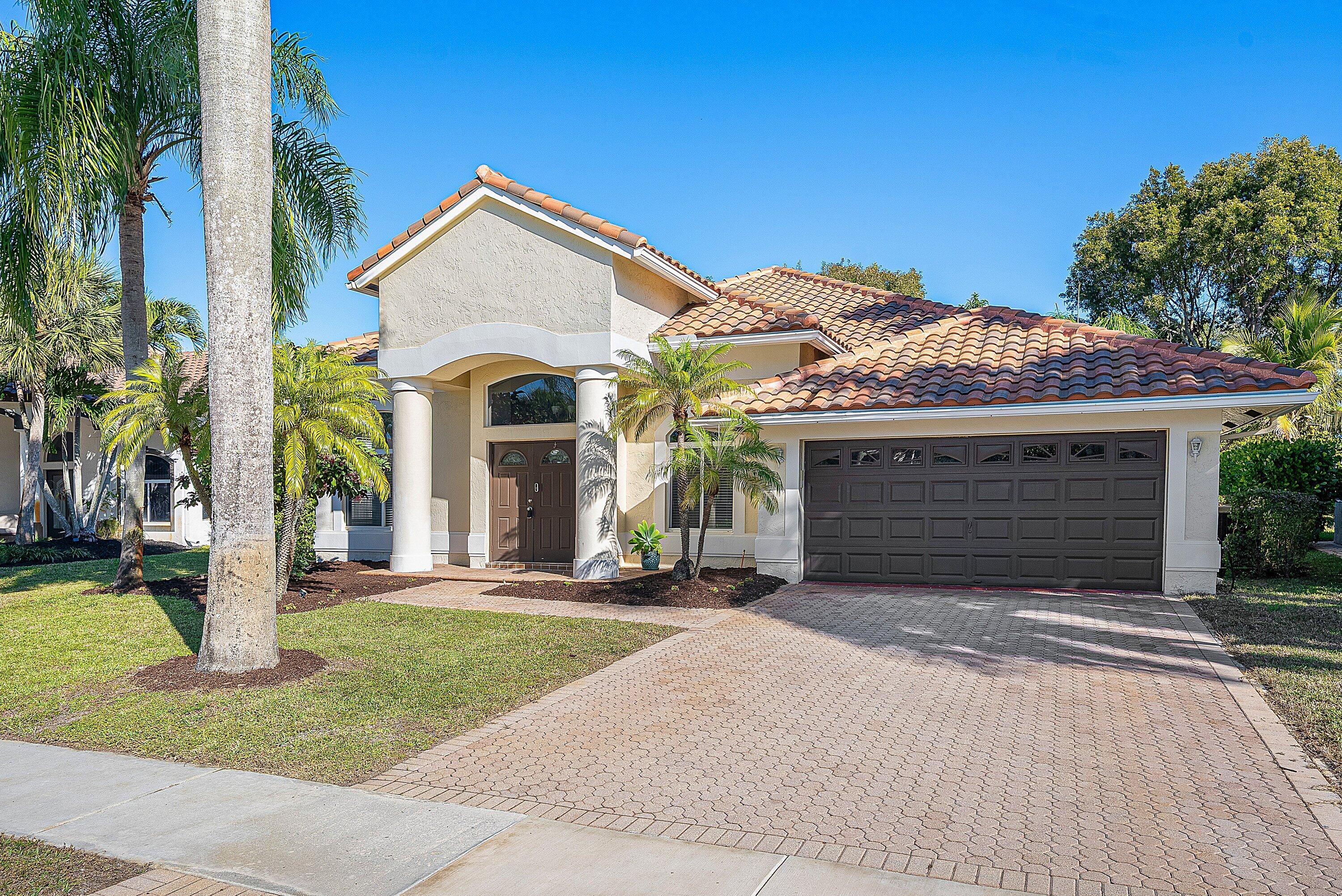 19712 Dinner Key Drive Boca Raton, FL 33498 - Photo 10 of 28 a front view of a house with a yard and garage