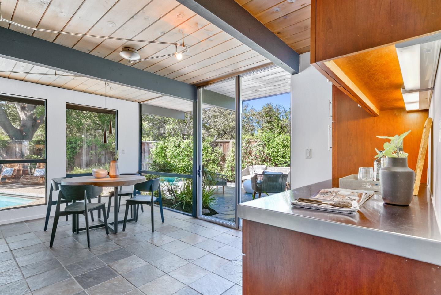 958 Eichler Drive Mountain View, CA 94040 - Photo 26 of 62 a dining room with furniture and a floor to ceiling window