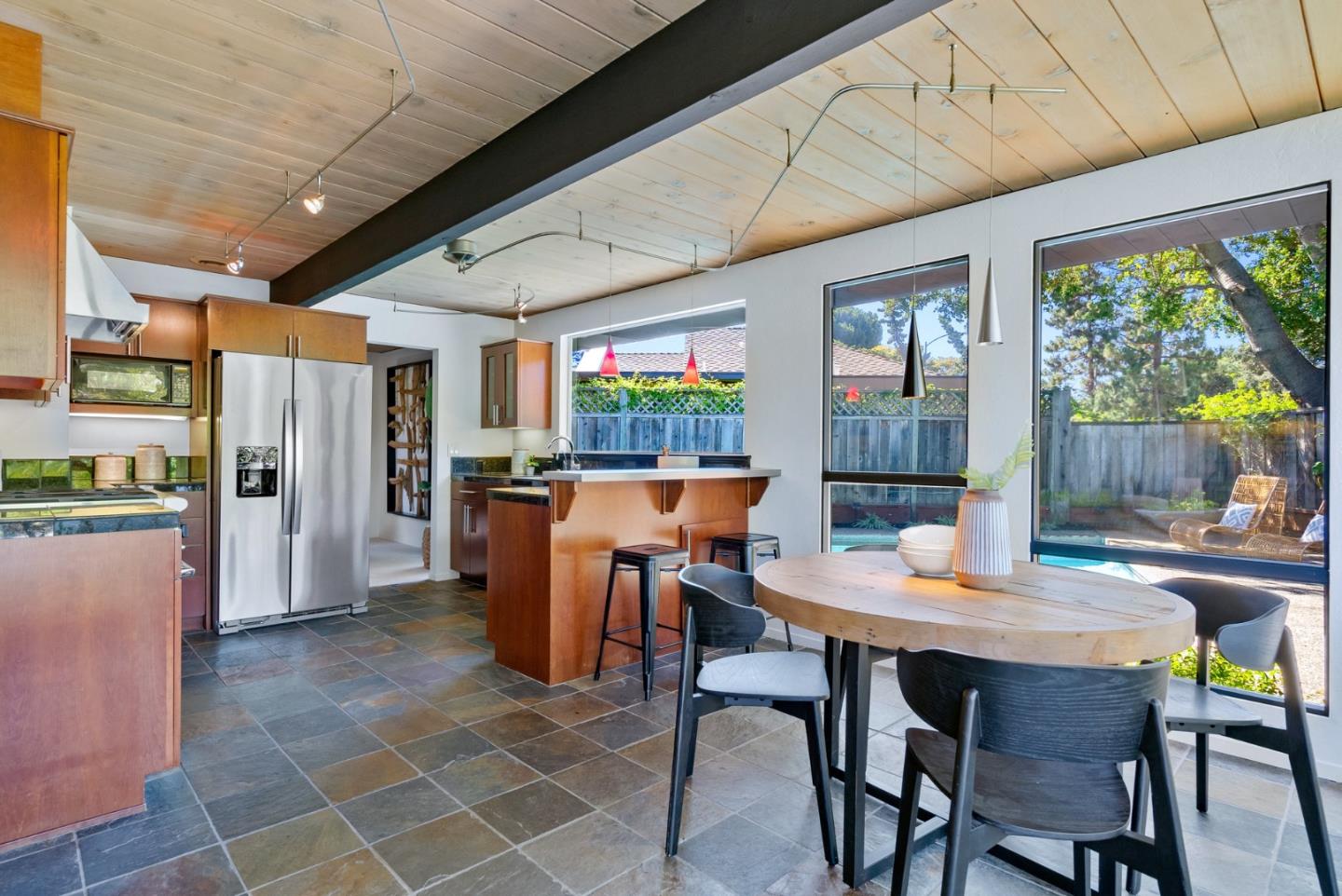 958 Eichler Drive Mountain View, CA 94040 - Photo 28 of 62 a dining room with stainless steel appliances a table chairs and a kitchen view