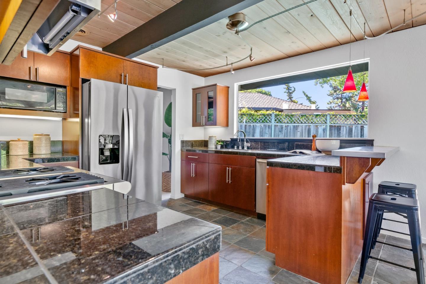 958 Eichler Drive Mountain View, CA 94040 - Photo 31 of 62 a kitchen with stainless steel appliances granite countertop a refrigerator and a wooden cabinets