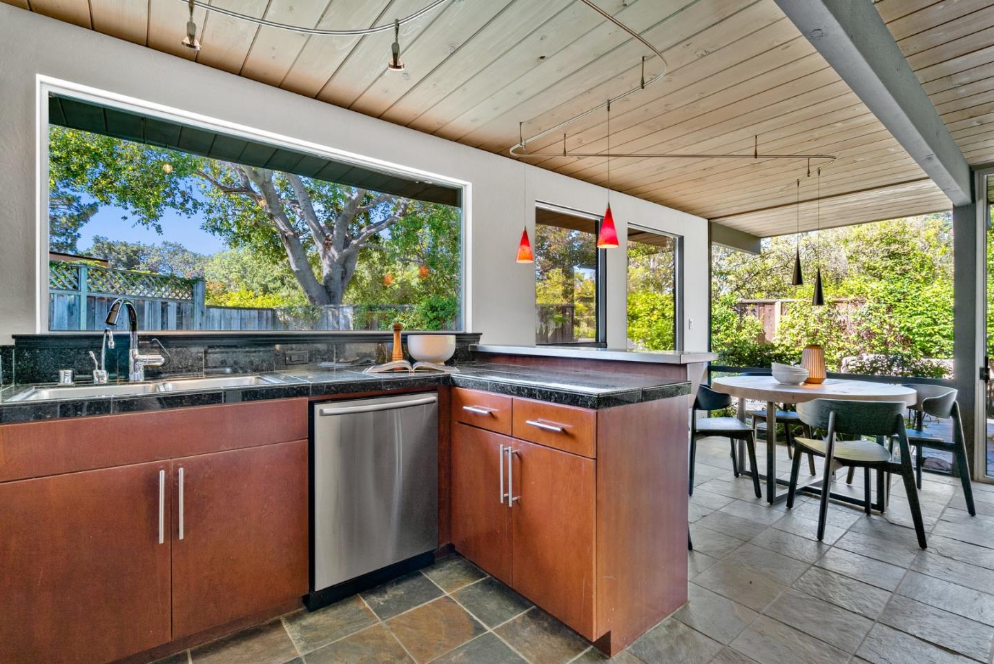 958 Eichler Drive Mountain View, CA 94040 - Photo 35 of 62 a kitchen with stainless steel appliances granite countertop a stove a sink dishwasher and wooden cabinets with wooden floor
