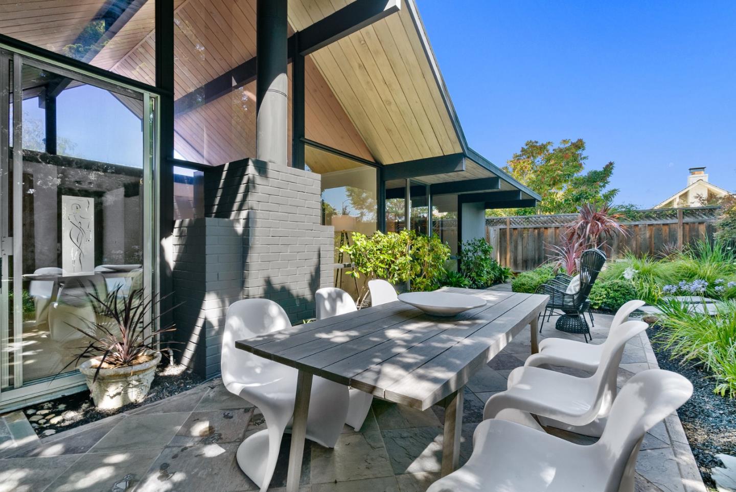 958 Eichler Drive Mountain View, CA 94040 - Photo 56 of 62 a view of a patio with table and chairs and potted plants