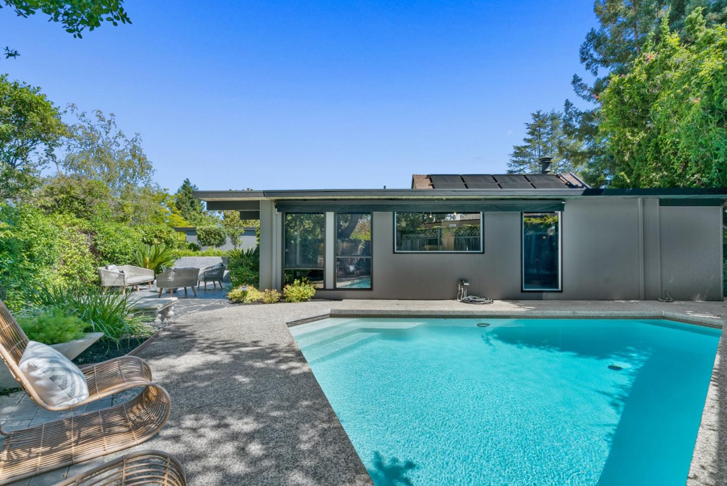 958 Eichler Drive Mountain View, CA 94040 - Photo 60 of 62 a front view of a house with a garden and yard