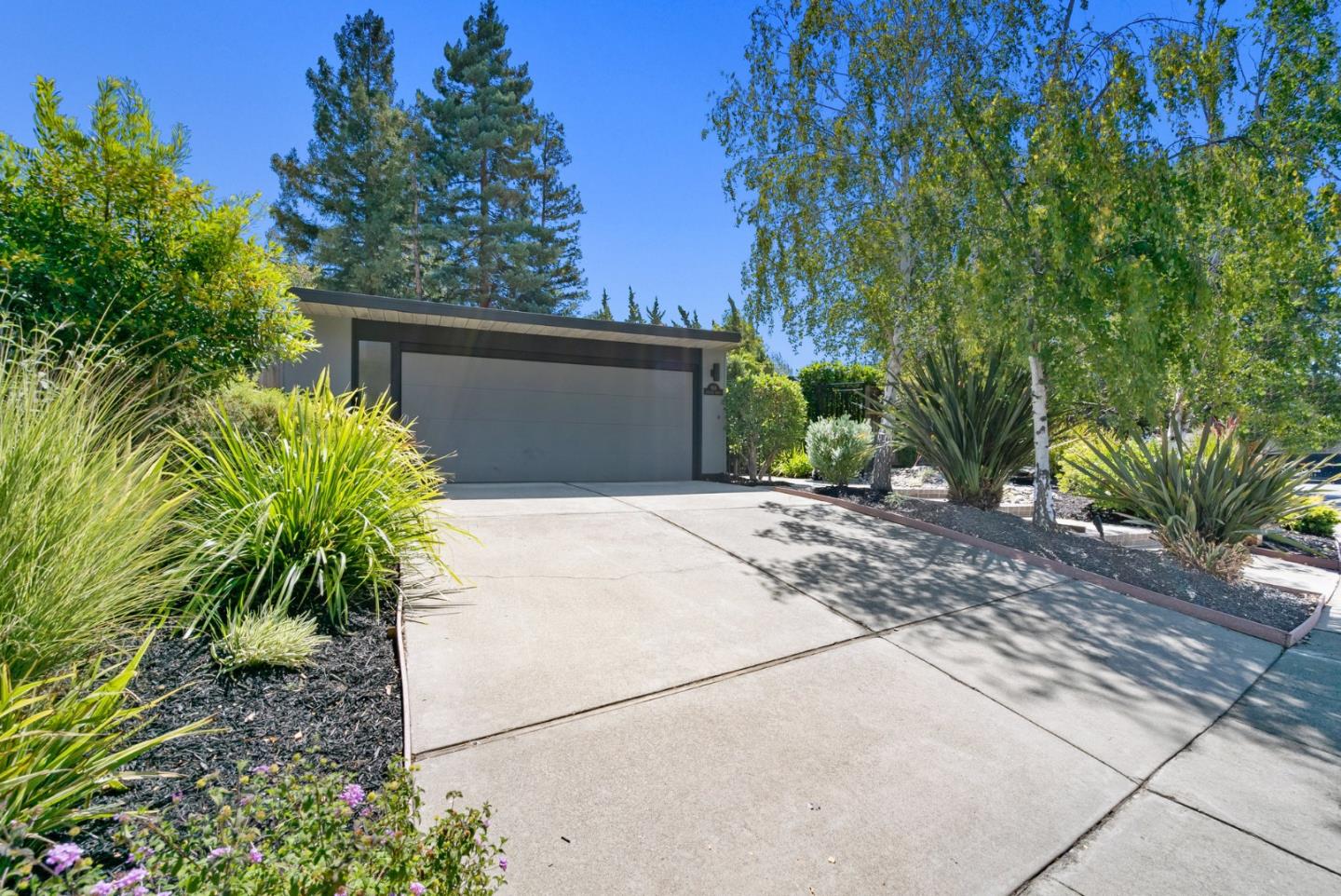 958 Eichler Drive Mountain View, CA 94040 - Photo 9 of 62 a front view of a house with a yard and a garage