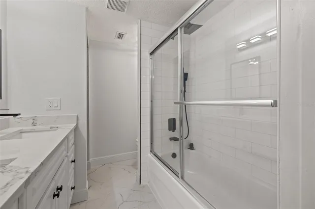 a bedroom with a bed and a tv on the dresser