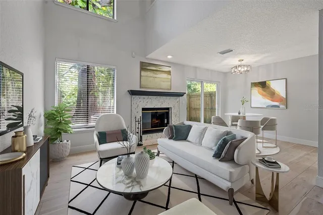 a living room with furniture fireplace and flat screen tv