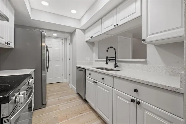 a kitchen with a sink and stainless steel appliances