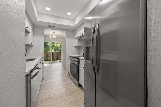 a kitchen with stainless steel appliances a refrigerator and a sink