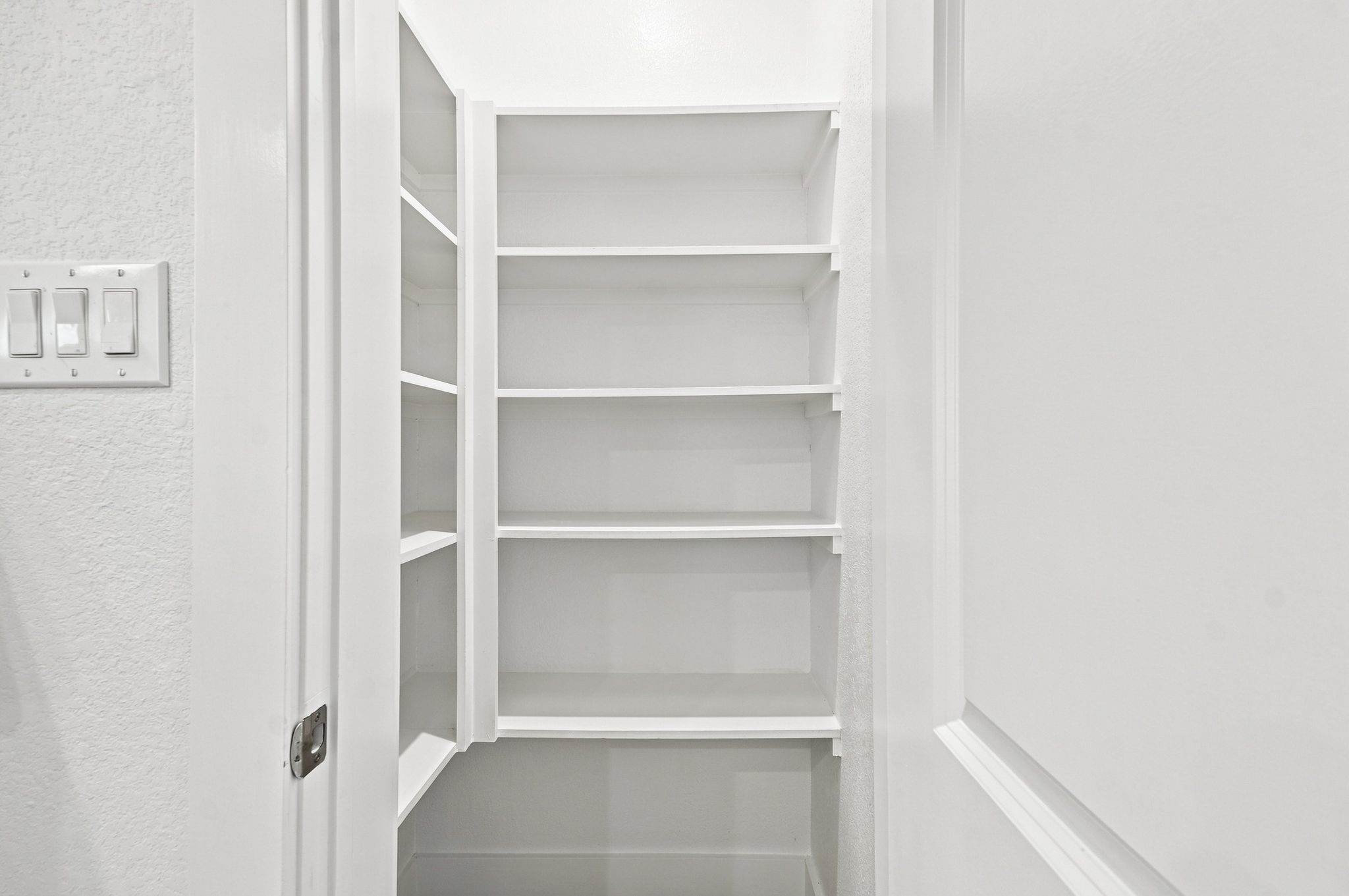 6063 Cebra Street Houston, TX 77091 - Photo 36 of 50 Convenient walk-in pantry with built-in shelving, providing plenty of organized storage for groceries and kitchen essentials. Photos are from a different property with the same floor plan, features, and finishes. **Orientation may vary.**