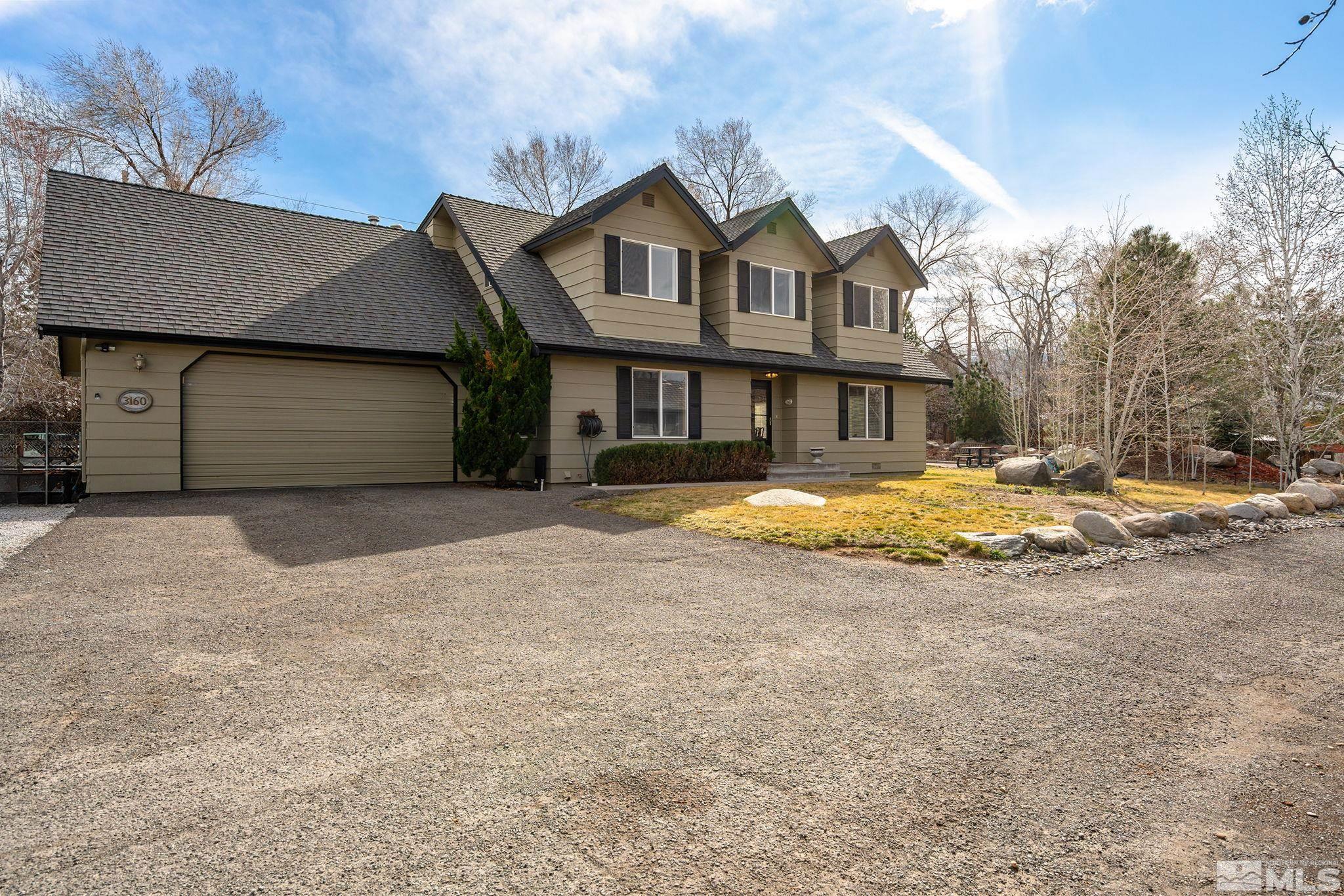 3160 Knight Road Reno, NV 89509 - Photo 2 of 39 a view of a house with a yard and garage