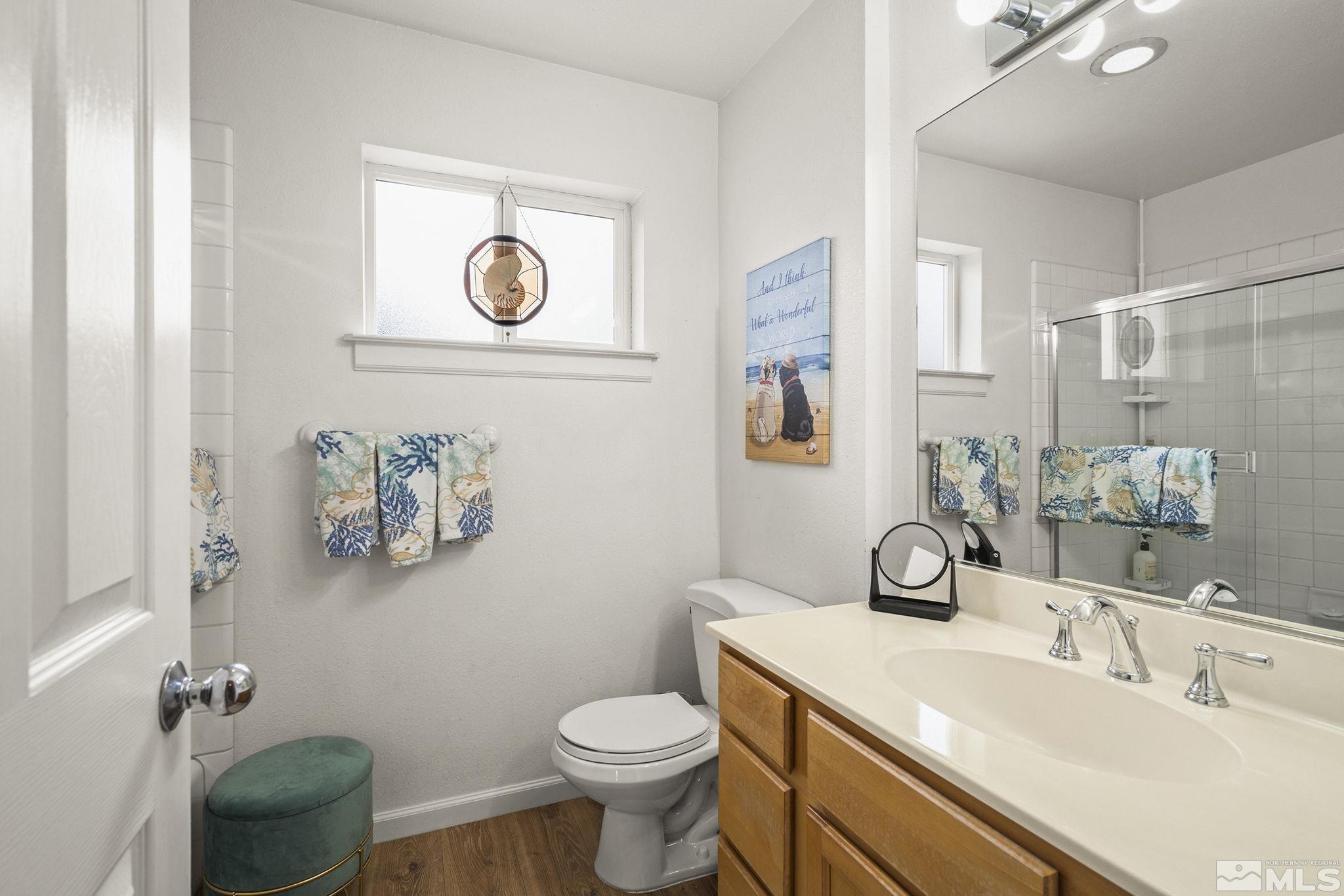 3160 Knight Road Reno, NV 89509 - Photo 21 of 39 a bathroom with a toilet sink and mirror