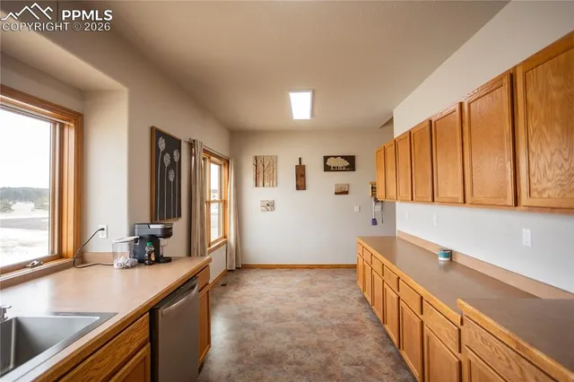 a kitchen with stainless steel appliances a sink and cabinets