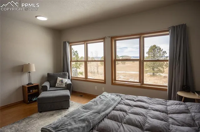 a bedroom with bed couch and window