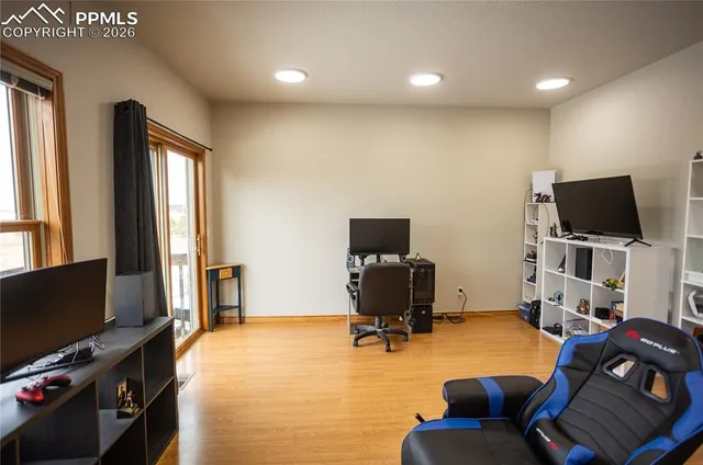 a livingroom with workspace and a window