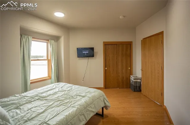 a bedroom with a bed and a window