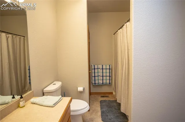 a white toilet sitting next to a bathroom sink