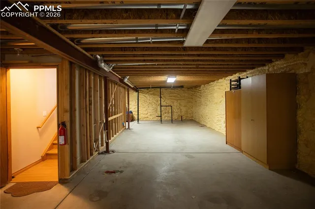 a view of empty room with wooden walls