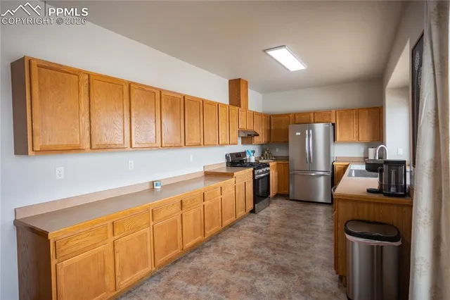 a kitchen with refrigerator cabinets and a sink
