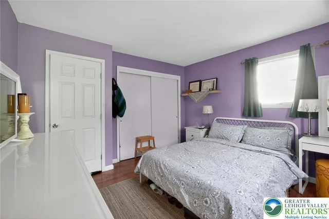 a bedroom with a bed and a mirror