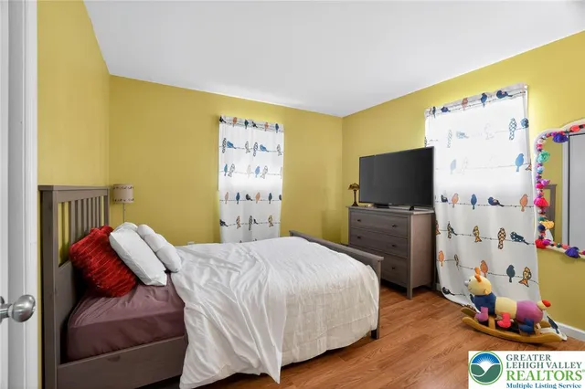 a bedroom with a bed and a flat screen tv