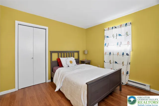 a bed sitting in a bedroom next to a blue wall