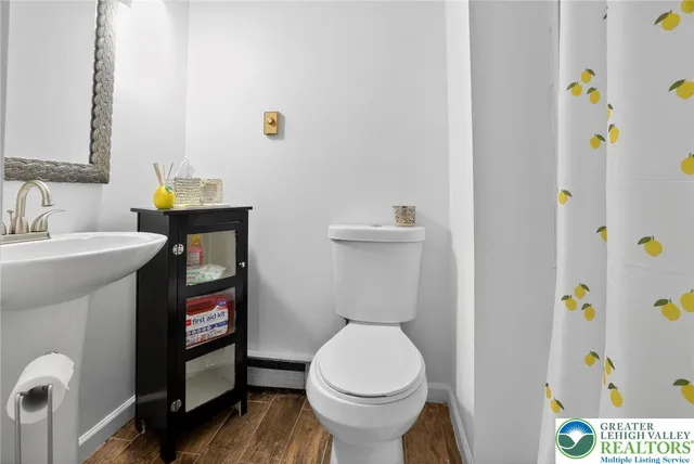a white toilet sitting next to a bathroom sink