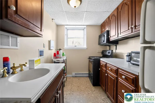 a kitchen with stainless steel appliances granite countertop a sink stove and cabinets