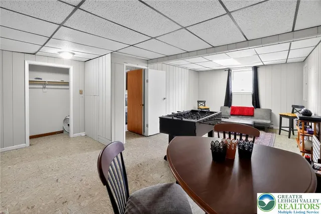 a dining room with furniture and a floor to ceiling window