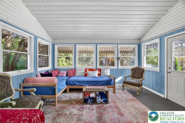 a living room with furniture and floor to ceiling windows