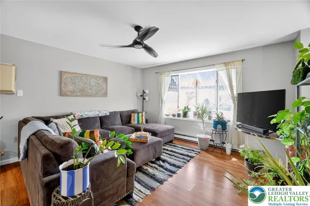 a living room with furniture and a potted plant