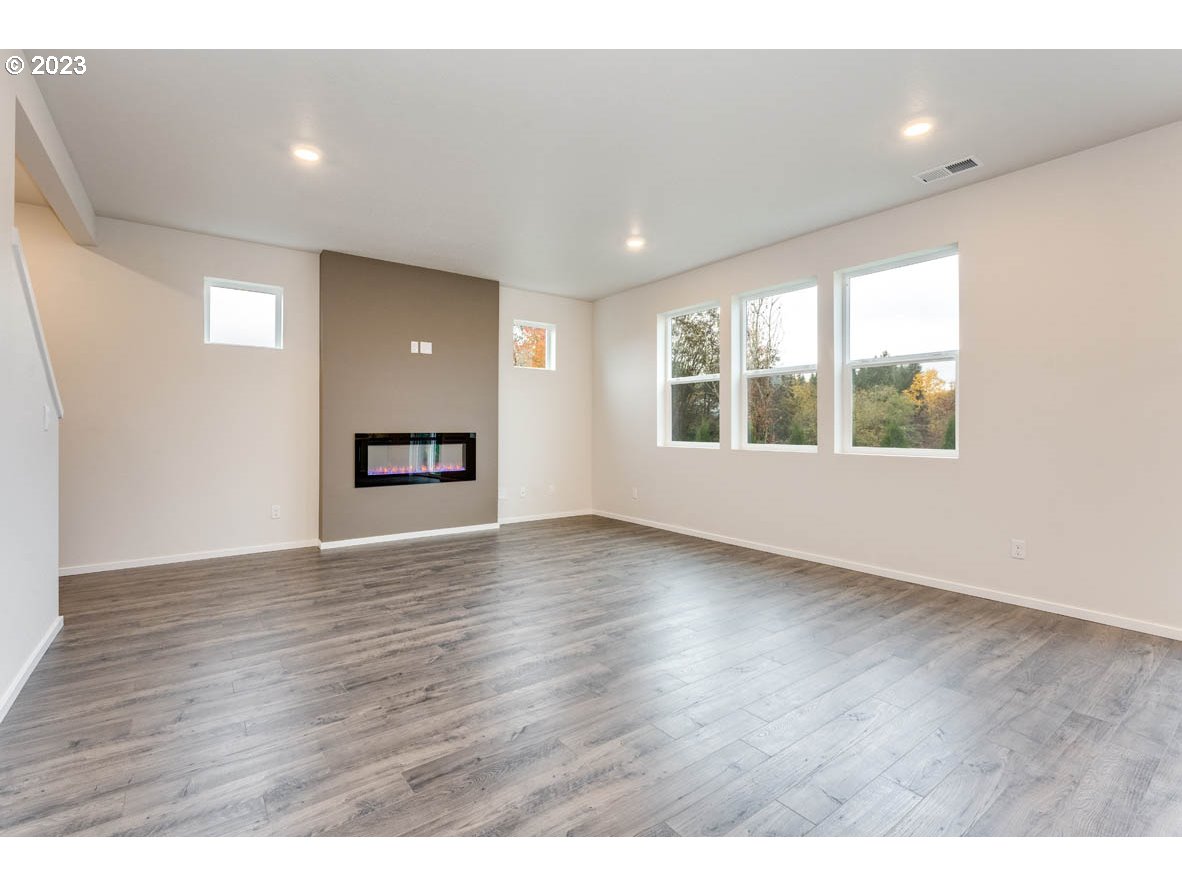 5629 Earth Street Northeast Dallas, OR 97338 - Photo 13 of 35 a view of an empty room with wooden floor and a window