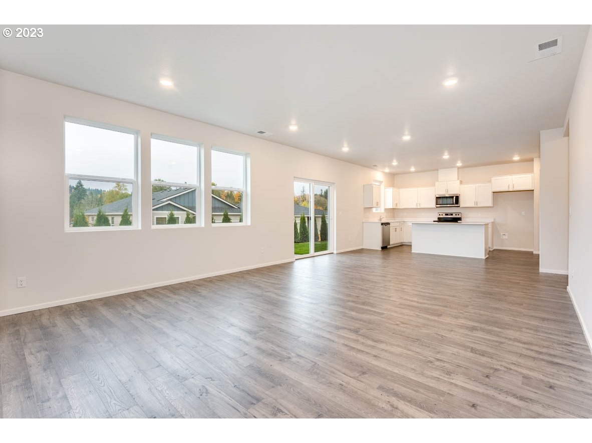 5629 Earth Street Northeast Dallas, OR 97338 - Photo 16 of 35 a view of an empty room with wooden floor and a window
