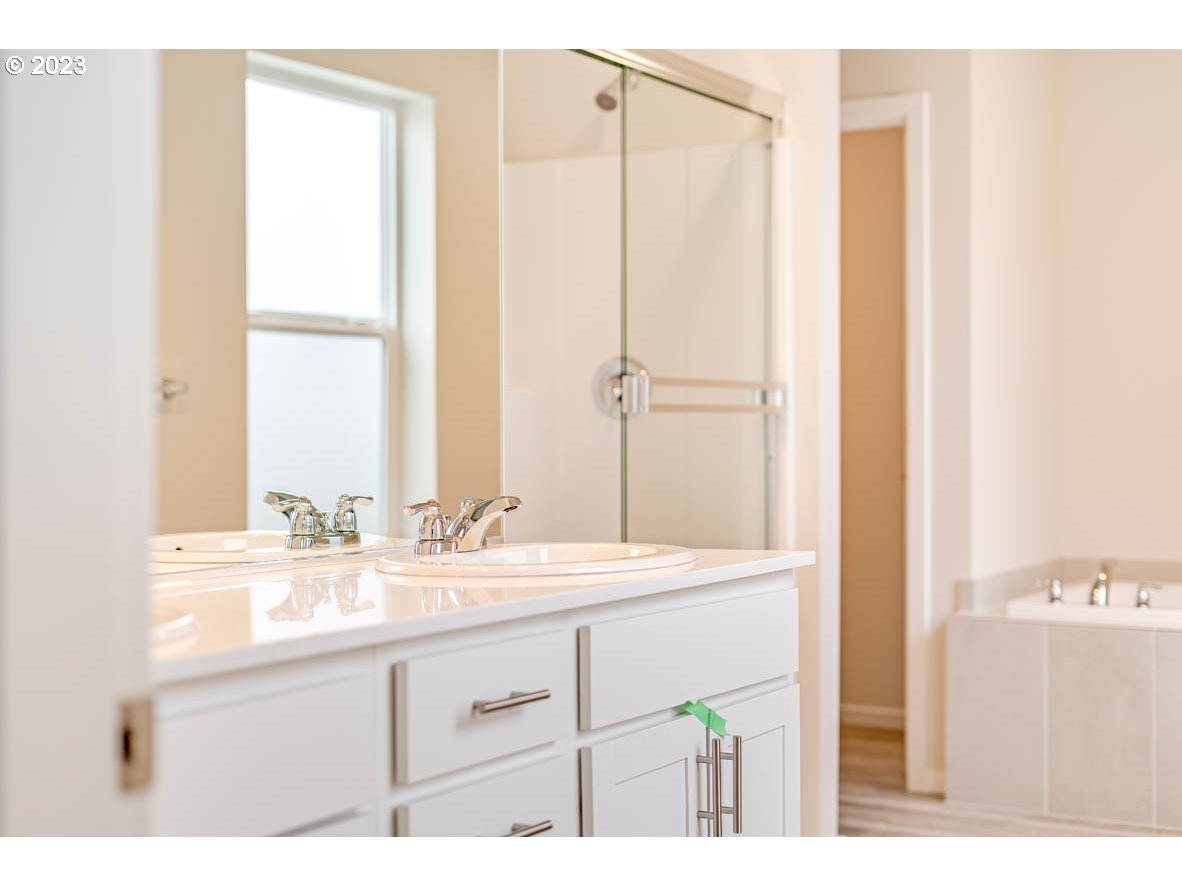 5629 Earth Street Northeast Dallas, OR 97338 - Photo 26 of 35 a bathroom with a double vanity sink and a mirror