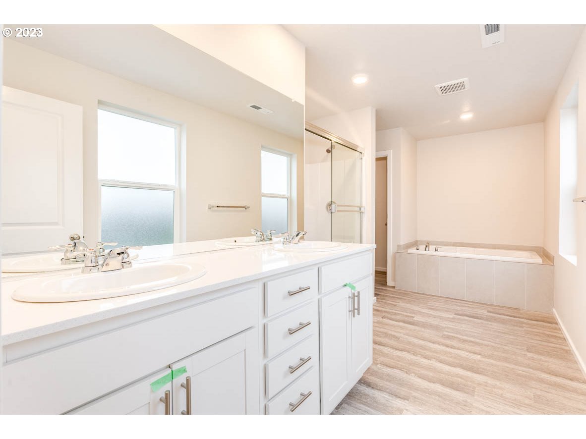 5629 Earth Street Northeast Dallas, OR 97338 - Photo 27 of 35 a bathroom with a sink a mirror and a shower