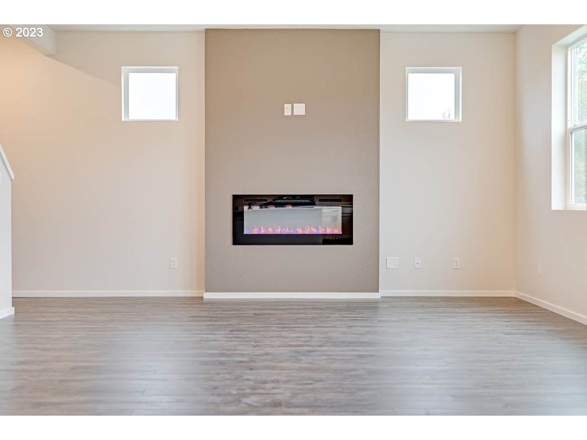 5629 Earth Street Northeast Dallas, OR 97338 - Photo 30 of 35 a view of an empty room with wooden floor and a window