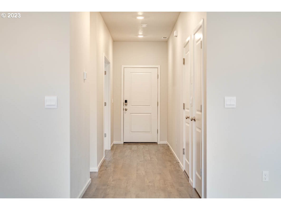 5629 Earth Street Northeast Dallas, OR 97338 - Photo 3 of 35 a view of a hallway with wooden floor