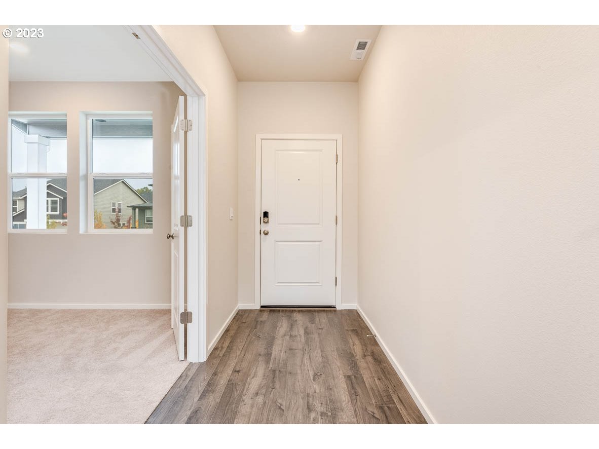 5629 Earth Street Northeast Dallas, OR 97338 - Photo 4 of 35 a view of an empty room with wooden floor