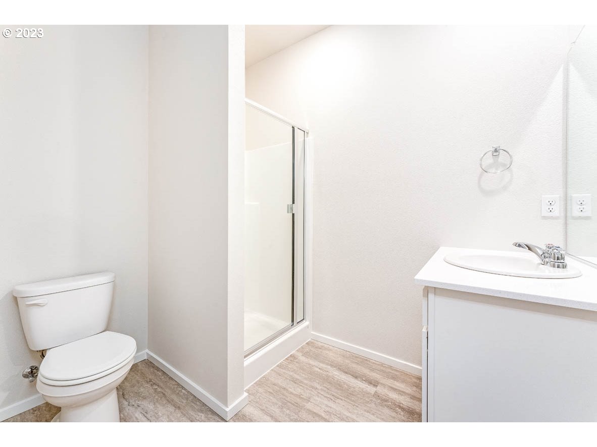 5629 Earth Street Northeast Dallas, OR 97338 - Photo 6 of 35 a bathroom with a toilet a sink and mirror