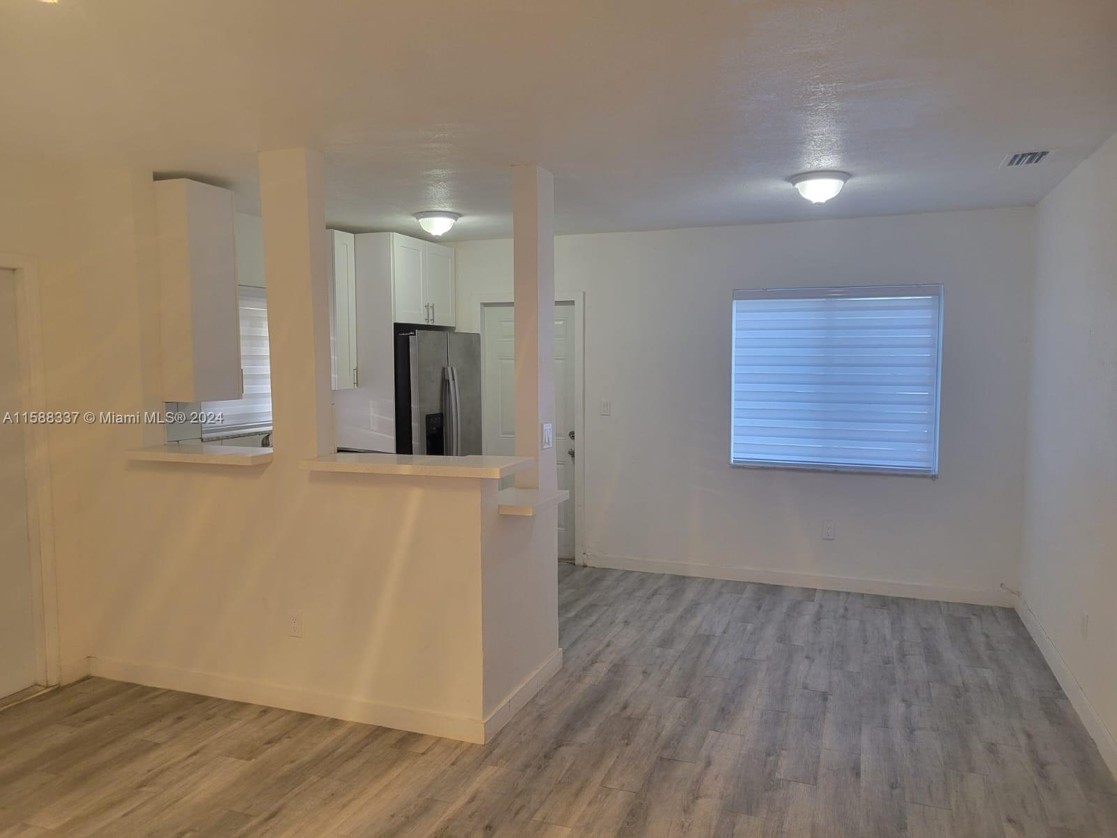 5922 Pierce Street, Unit 1 Hollywood, FL 33021 - Photo 6 of 7 wooden floor in an empty room with a window