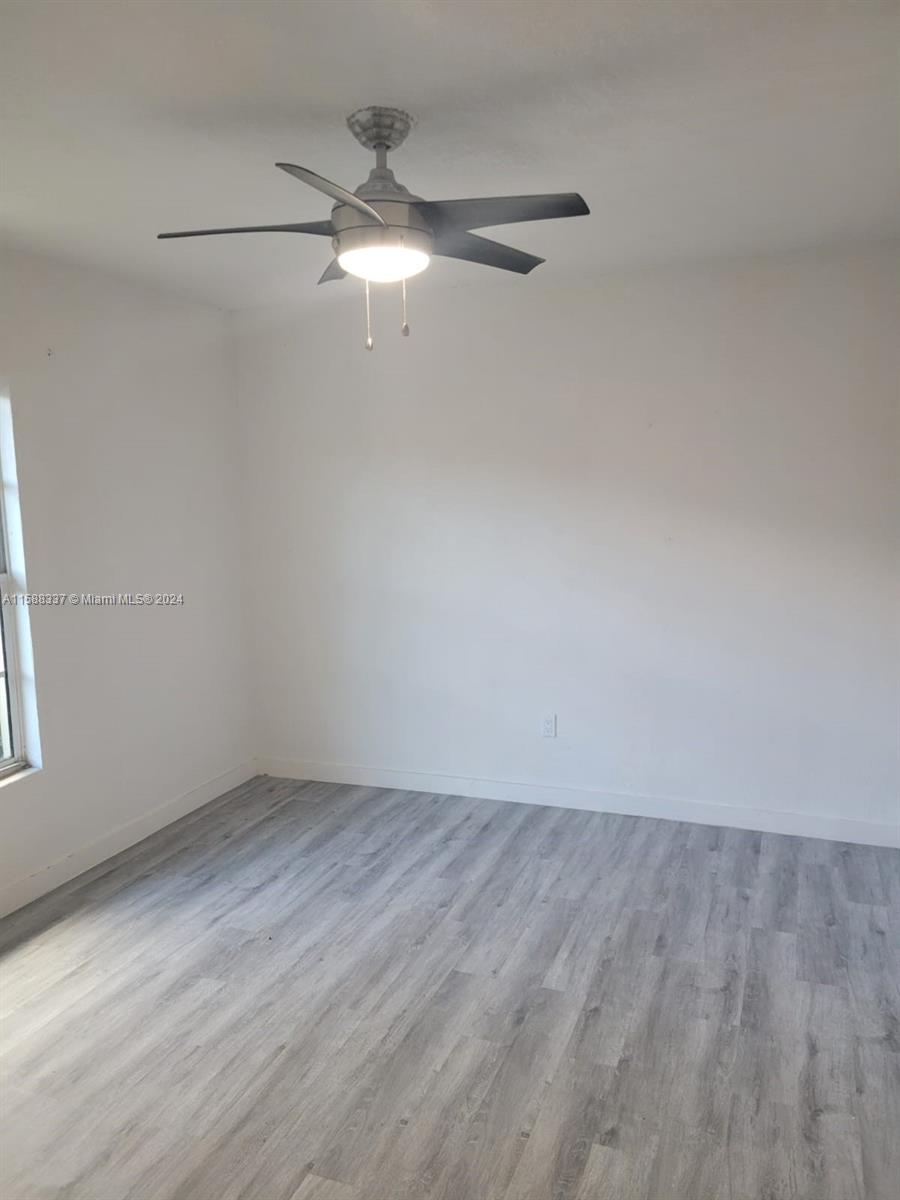 5922 Pierce Street, Unit 1 Hollywood, FL 33021 - Photo 7 of 7 wooden floor in an empty room