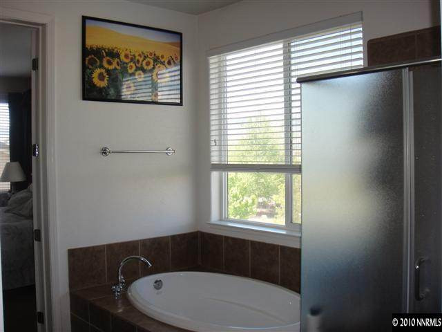 10593 Blockade Drive Reno, NV 89521 - Photo 6 of 9 a bathroom with a toilet and a window