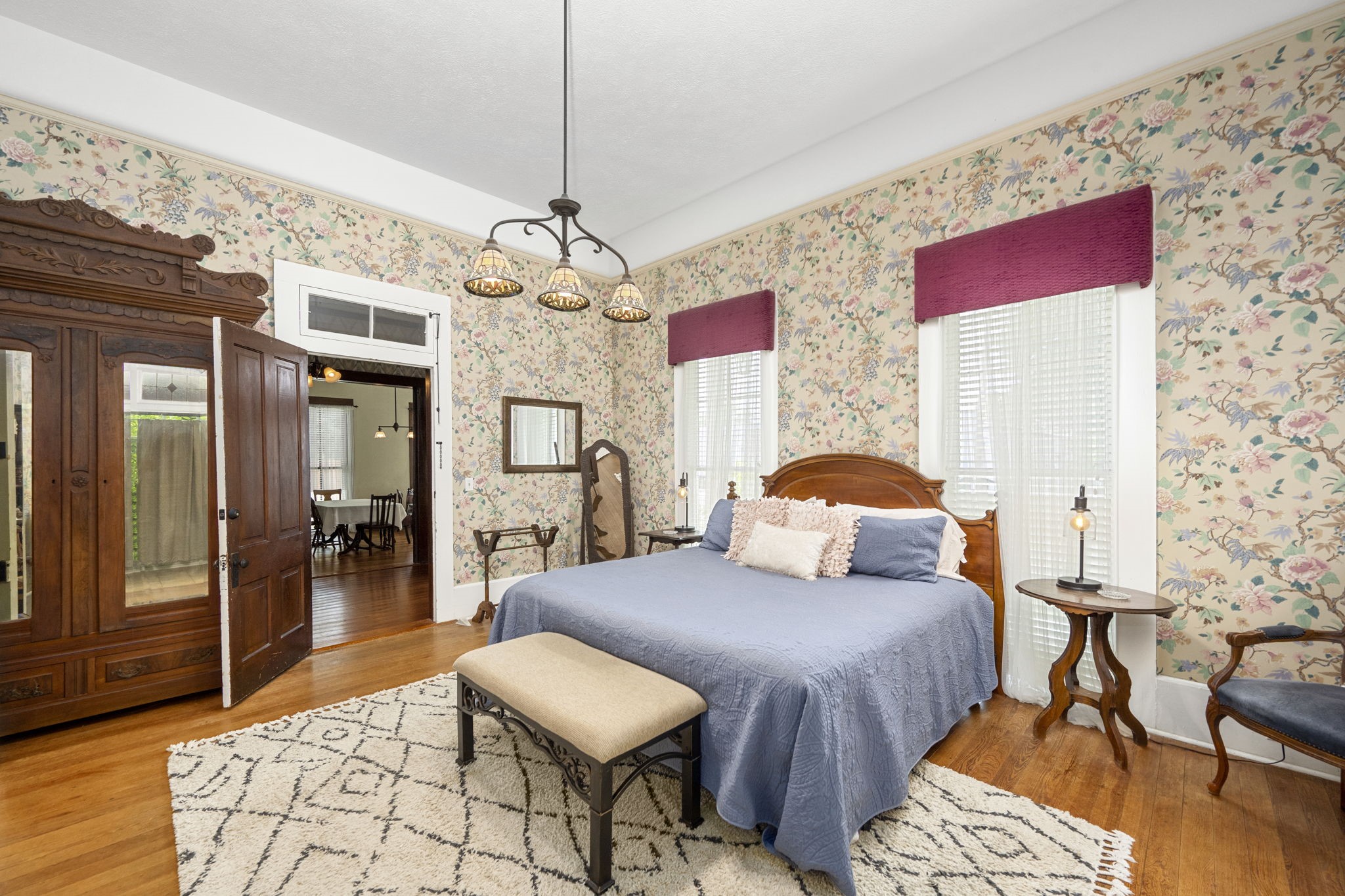 1118 Prairie Street Columbus, TX 78934 - Photo 19 of 34 a bedroom with furniture and a chandelier