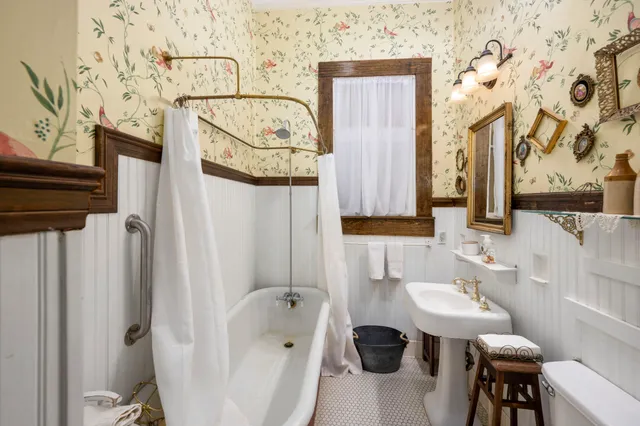 a bathroom with a sink and mirror with toilet