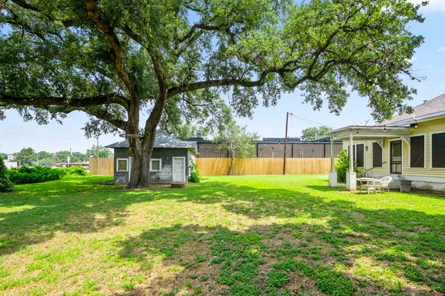 a view of a house with a yard and sitting area