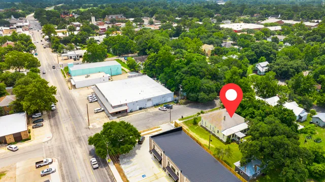 an aerial view of a house with a yard and fountain
